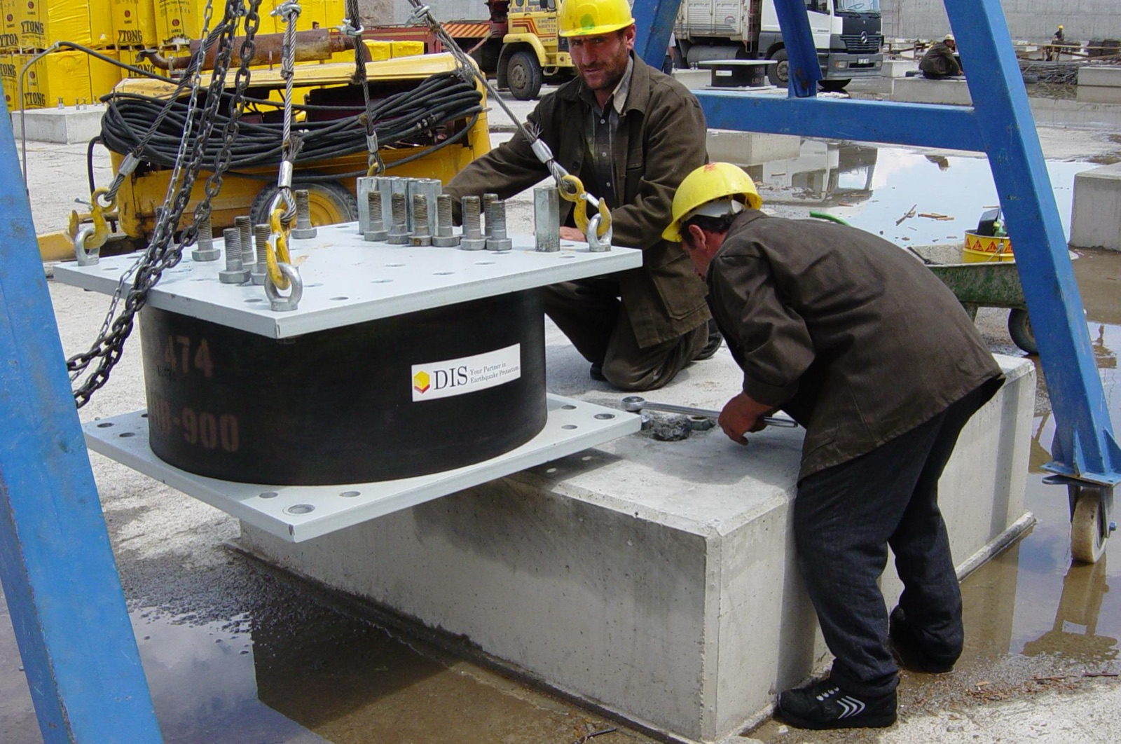 Crew installing a lead rubber bearing on site